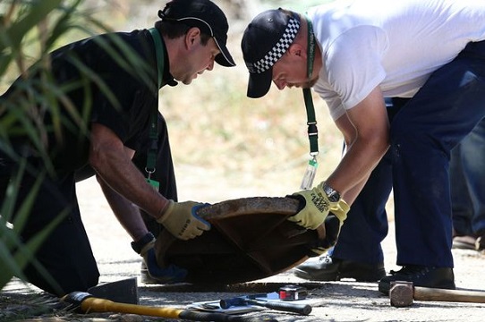 British police use cameras to look down manhole covers as part of new searches in Praia Da Luz