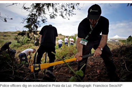 Police officers dig on scrubland in Praia da Luz. Photograph: Francisco Seco/AP