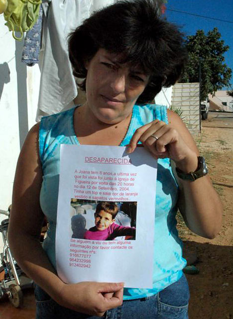 A MOTHER'S AGONY: Leonor Cipriano in 2004 with a poster of her missing daughter Joana.