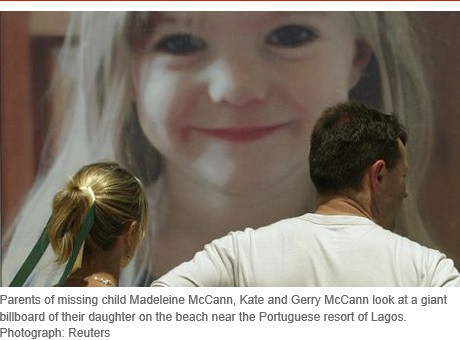 Parents of missing child Madeleine McCann, Kate and Gerry McCann look at a giant billboard of their daughter on the beach near the Portuguese resort of Lagos. Photograph: Reuters